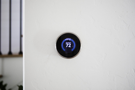 A smart thermostat displays the temperature, set to 72 degrees.