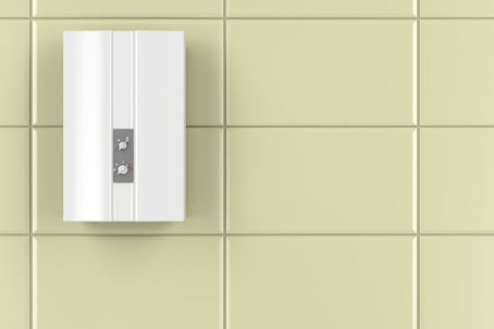 A Modern wall-mounted electric water heater with two knobs on a tiled wall.