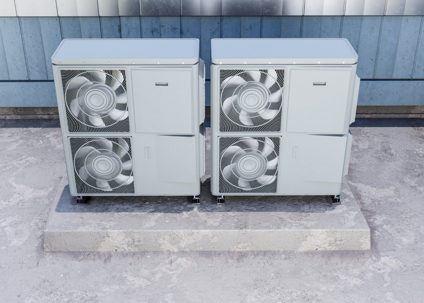 Two air conditioning units are mounted on a concrete pad.