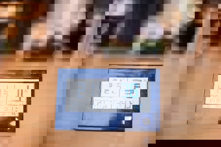 a digital thermometer showing temperature and humidity.